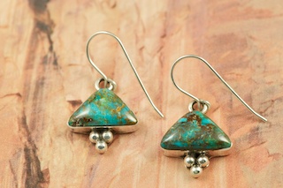 Genuine Sunnyside Turquoise set in Sterling Silver French Wire Earrings. The matrix on this rare stone is outstanding. The Sunnyside mine is located in northern Nevada near the town of Tuscarora in the Tuscarora mountain range. The mine is no longer in operation as it has become part of a gold mining operation and a privately owned ranch. The Sunnyside mine was mined mostly in the 70's. You won't find much of this great turquoise around anymore except for old stashes. Created by Navajo Artist Eloise Jackson. 